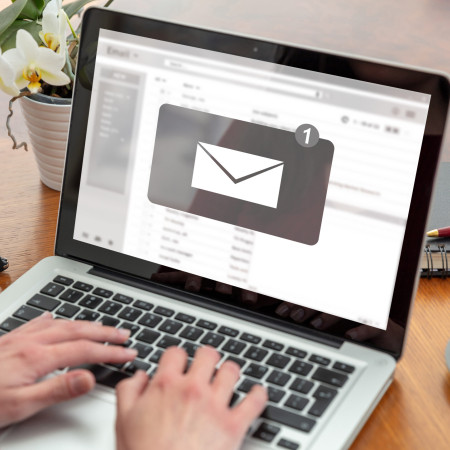 Email notification for a woman using a laptop.