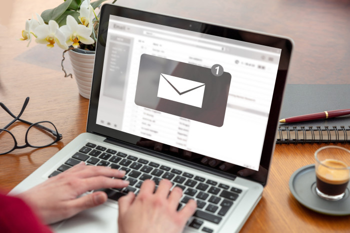 Email notification for a woman using a laptop.